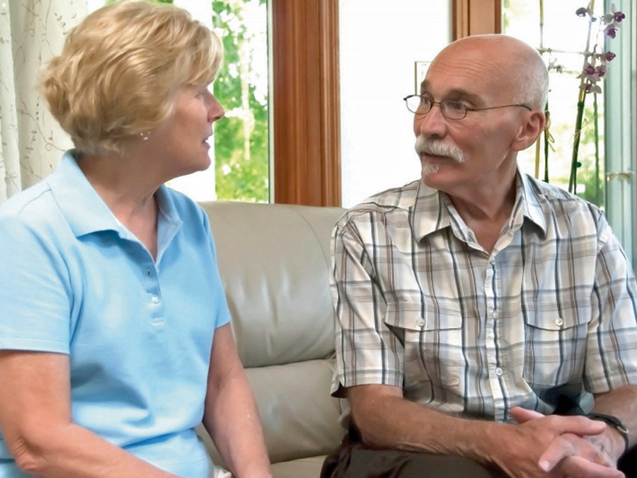 Man and woman talking on couch Man and woman talking on couch